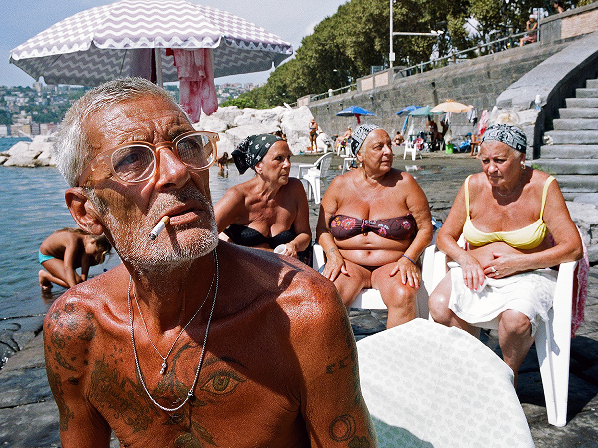 Group of elderly beachgoers in Naples, Italy
