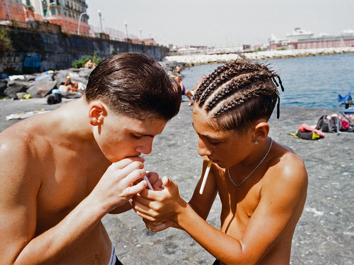 Two boys smoking cigarettes in Naples