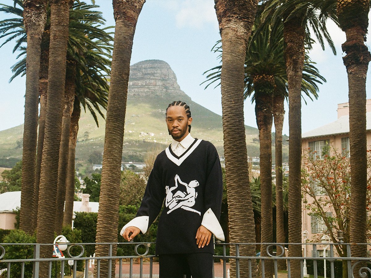 Thebe Magugu on the balcony of the Thebe Magugu Suite with Palm Avenue and Lion’s Head in the background